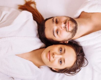 Beautiful couple relaxing in spa center lying on massage table; Shutterstock ID 1006728721